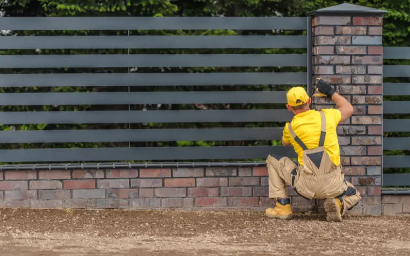 fence-contractor-inspecting-a-new-fence-build